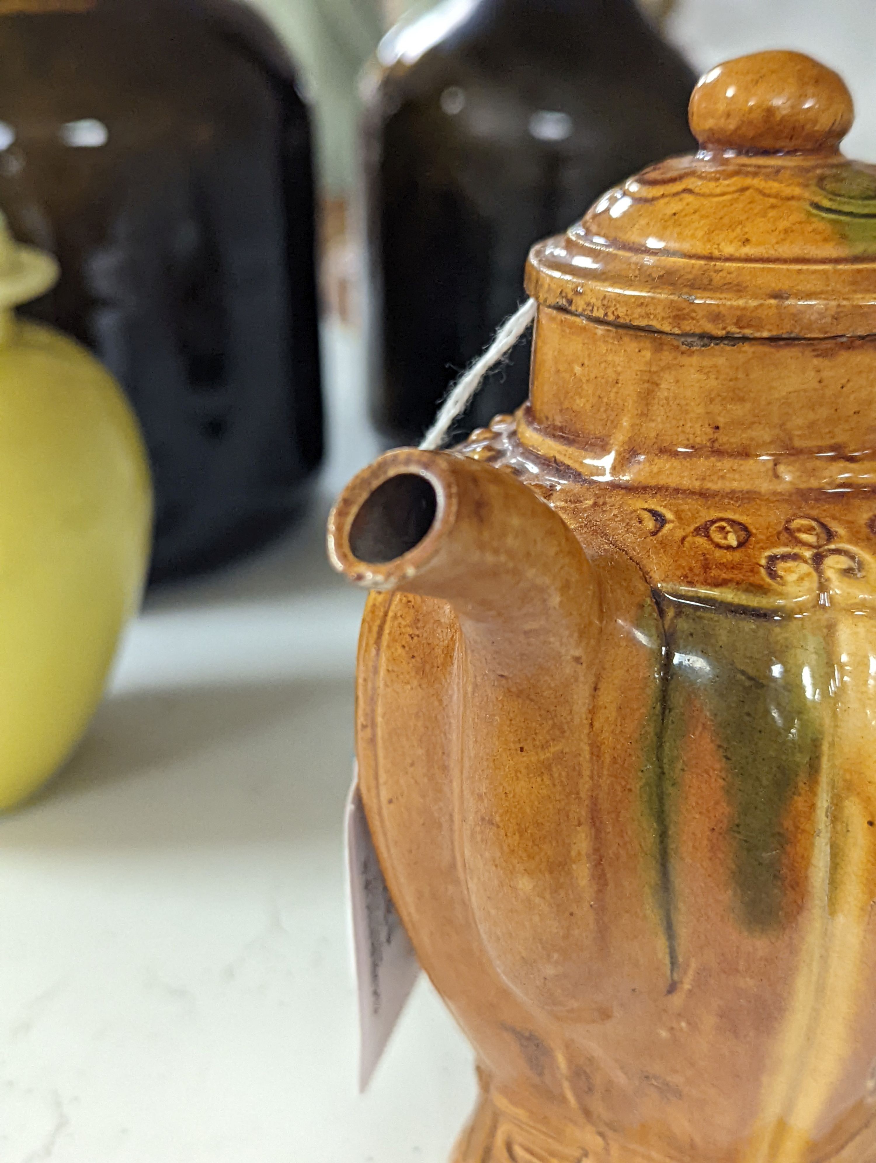 A Chinese enamelled yellow-ground jar and cover, a pottery teapot and cover and a flambe vase, latter 13cm